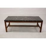 A rectangular hardwood and marble topped coffee table, on square supports united by lower stretcher,
