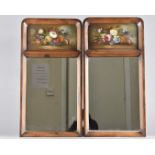 A pair of fruitwood veneered mirrors, with still life painted panels by E M Ball, 53.5 cm x 27.5 cm