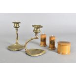 A pair of art nouveau brass candlesticks, with triangular bases embossed with stylised leaves and