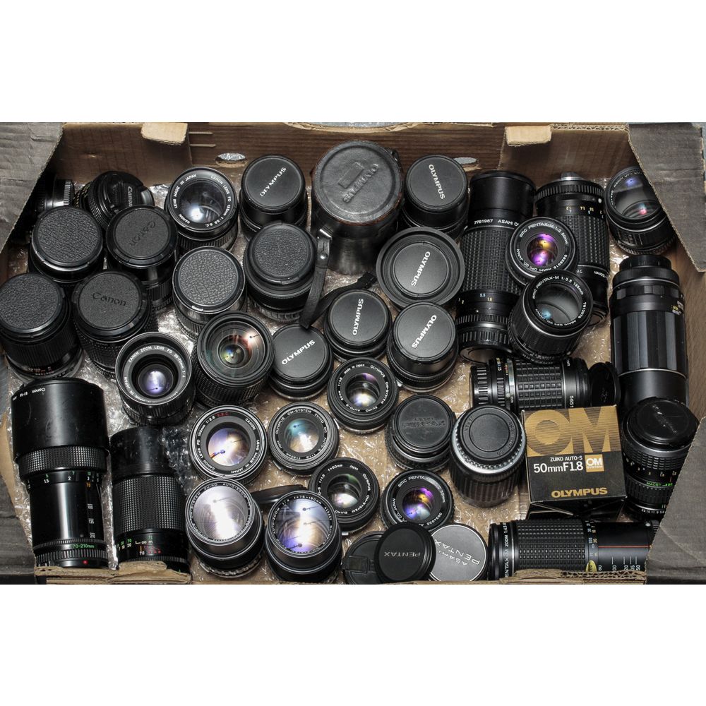 Olympus OM System Lenses, various examples together with additional lenses from Pentax and Canon