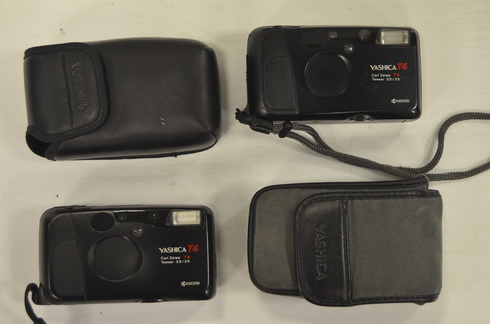 Yashica Compact Cameras, A pair of black Yashica T4, Zeiss Tessar 35mm f/3.5 lenses both in maker'