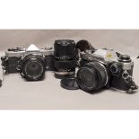 Olympus OM system SLRs, a OM-1 with a 50mm f/1.8 lens and a OM-10 with a 28mm f/2.8 lens together