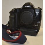 A Canon EOS 3 SLR Body, complete with a Canon Power Drive Booster E1