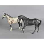 A dapple grey Beswick horse, together with a matt black Beswick horse (2)