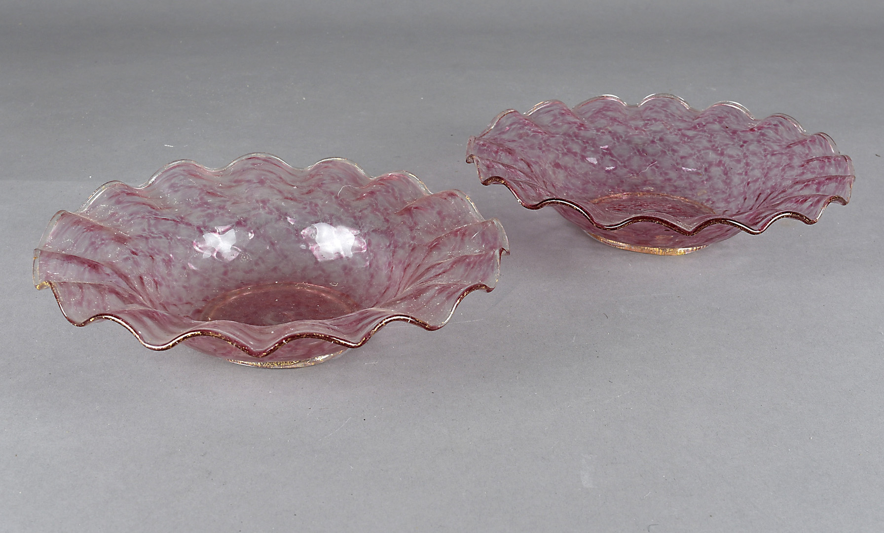 A pair of Venetian glass circular dishes, of lattice moulded design with crimped rim, pink and