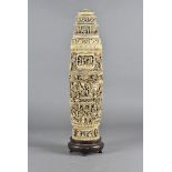 An early 19th Century Chinese ivory twin handled vase and cover, with all over carved decoration