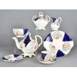 A 19th century Gaudy Welsh 'Tulip pattern' twelve setting tea services, including a large tea