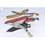 A group of four Middle Eastern knives, including a bone handled Kukri, all with scabbards (4)