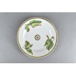 An early 19th century Swansea porcelain plate, circular shape with green leaf designs, heightened in