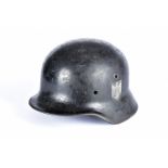 A Third Reich single decal helmet, black painted with eagle and swastika painted shield to one side,
