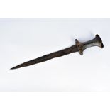 A late 17th/ early 18th Century tribal dagger, possibly African, having carved wooden handle, with