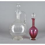 An Edwardian glass wine carafe, with an engraved body of scrolls, beads and festoons and stopper,