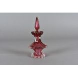 A 19th Century cranberry glass scent bottle and stopper, the hexagonal body with shaped sides on a