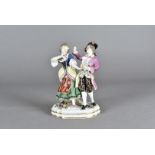 A European porcelain figure group, modelled as a dancing couple, on an oval base, painted in