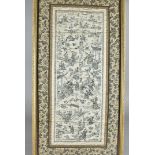 A late 19th Cenutry Chinese framed silk panel, comprising two sleeve bands sewn together within a