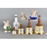 A set of four graduated Wade blended scotch whisky Bells decanters, with contents together with a