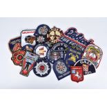 A collection of framed and loose Fire Brigade cloth badges, British and Overseas, including Florida,