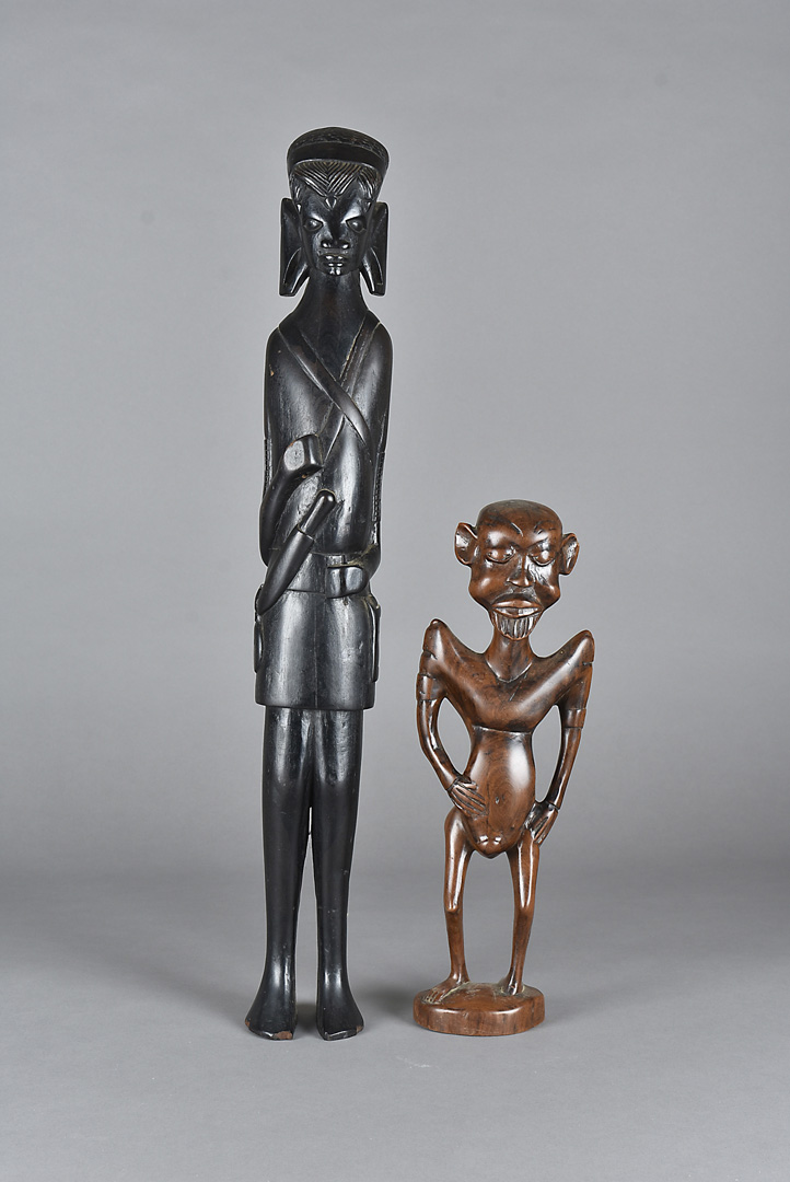 Two African hardwood figures, modelled as gentleman with broad shoulders with hand son hips and