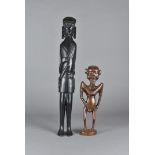 Two African hardwood figures, modelled as gentleman with broad shoulders with hand son hips and