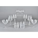 A collection of part suite of cut glass ware, including six wine, four brandy balloons, other cut
