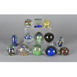 A collection of miscellaneous glass paperweights, including one modelled as an elephant, another