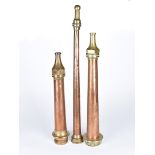 Three vintage brass and copper fire hose nozzles, one by Shand Mason & Co, all of different sizes