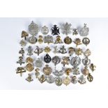 A large collection of cap badges, including Royal Highlanders Black Watch, 7th & 8th (Leeds