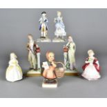 A collection of porcelain and pottery figures, including a Hummel figure of a young girl with