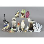 A quantity of model bird figures, in porcelain, pottery, horn and other materials