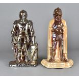 Two art deco cast iron lustre companion sets, modelled as knights, 35 cm high