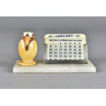 An art deco desk calendar, modelled as a ceramic exotic bird on onyx base with changeable ivorine