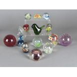A collection of 20th Century glass, resin and hardstone paperweights, one modelled with a seahorse