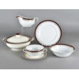 An Alfred Meakin burgandy and gilt border dinner service, with soup bowls, tureens, sauce boats etc