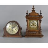 A 19th Century walnut eight day mantel clock, with brass face and arabic numerals, 47 cm high