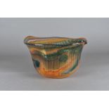 A 20th Century British art glass bowl, by Nick Osler, the green and orange graal design with