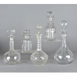 Five glass decanters and stoppers