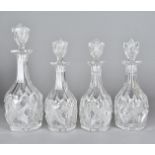 Four 19th Century cut glass decanters, having diamond cut design to faceted bodies with matching