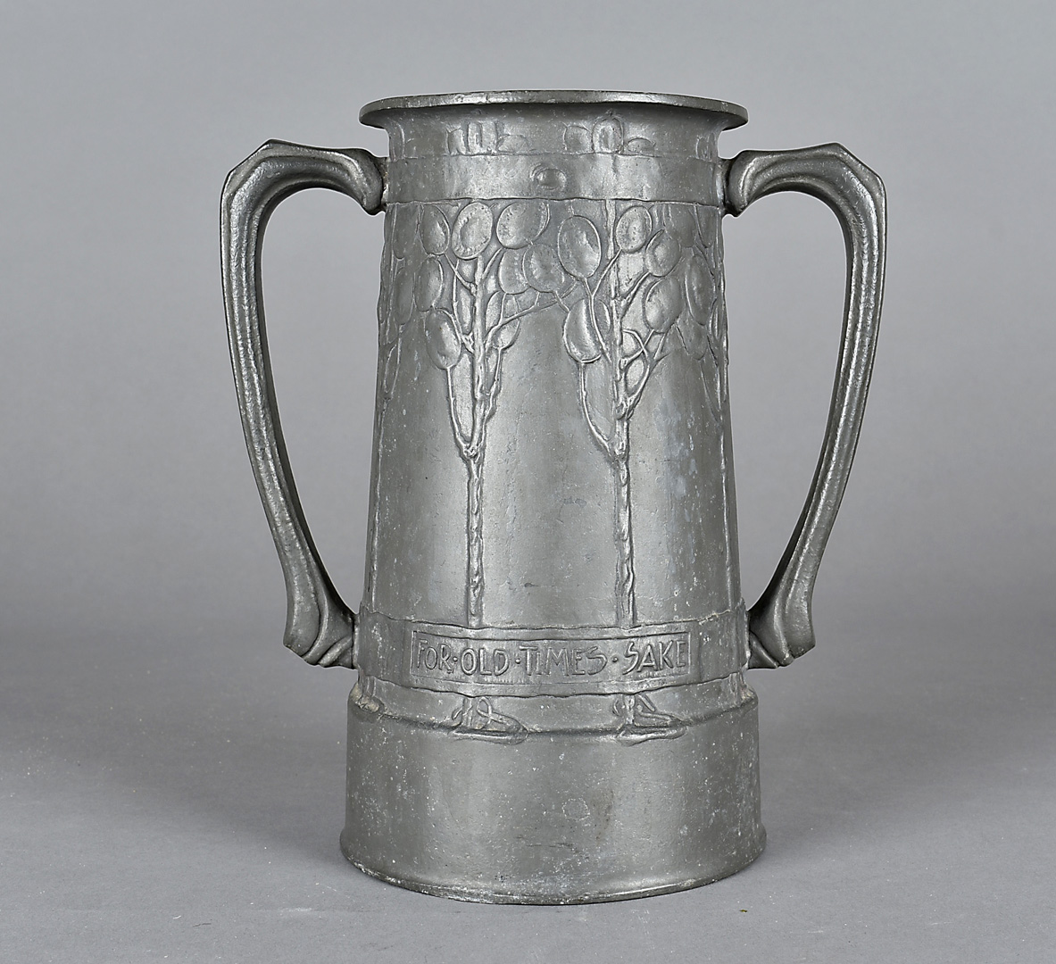 A Liberty & Co pewter Tudric loving cup, designed by David Veazey with Honesty plants and motto 'For