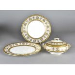 An Edwardian Cauldon limited part dinner service, comprising six gilt dinner plates, a pair of