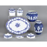 A Wedgwood blue and white dressing table set, the oval shaped jars and covers upon an oval tray with