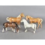 Two Beswick palamino horses, together with a grey stallion marked Welsh M and a Sylvac pony (4)