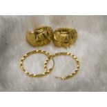 Two pair of Middle Eastern yellow metal earrings, one hoop style, the other cuff style, appear to be