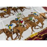 A Gucci silk scarf, with race horse and jockey designs, boxed (2) box is a bit tatty