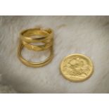 Three 22ct gold wedding bands, two plain, one faceted, 11g, together with a George V half