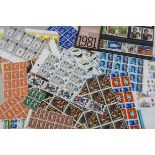 A collection of unused British stamps, dating from the 1950s onwards, some face value, in folders