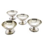 A set of four George III silver table salts by Henry Chawner, circular on spreading foot with reeded