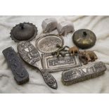 A three piece early 20th century Indian silver dressing table set, together with two similar