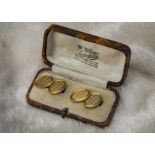 A pair of vintage 9ct gold cufflinks, having engine turned oval panels joined by chains, 12g, with a