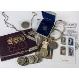 A collection of coins and jewellery, including two 1970s silver ingots on chains, two further