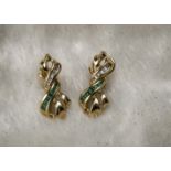 A pair of 14ct gold emerald and diamond earrings, the bow like twist mounts, 3cm, set with a row